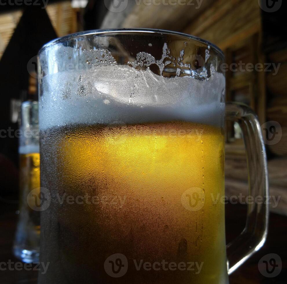 Two pints of craft beer with froth on the glass on the wood table photo