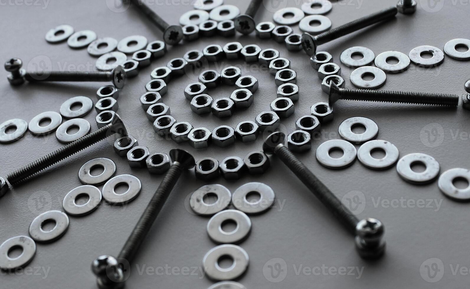 Shiny Steel Nuts, Washers And Variety Bolts Arranged With Symbolic Star Shape photo