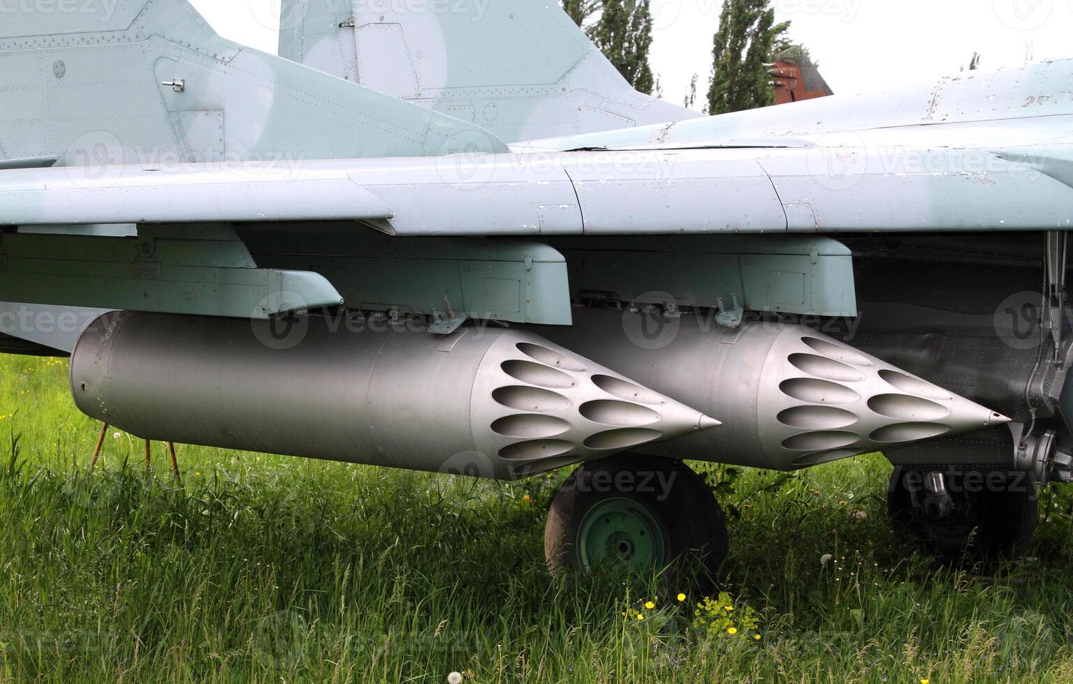 Rocket launcher system under the wing of military fighter photo