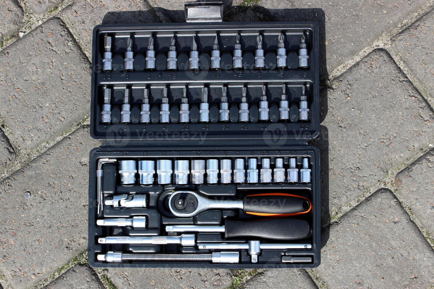 Hand Tools Set In Black Case On A Concrete Slabs Background photo