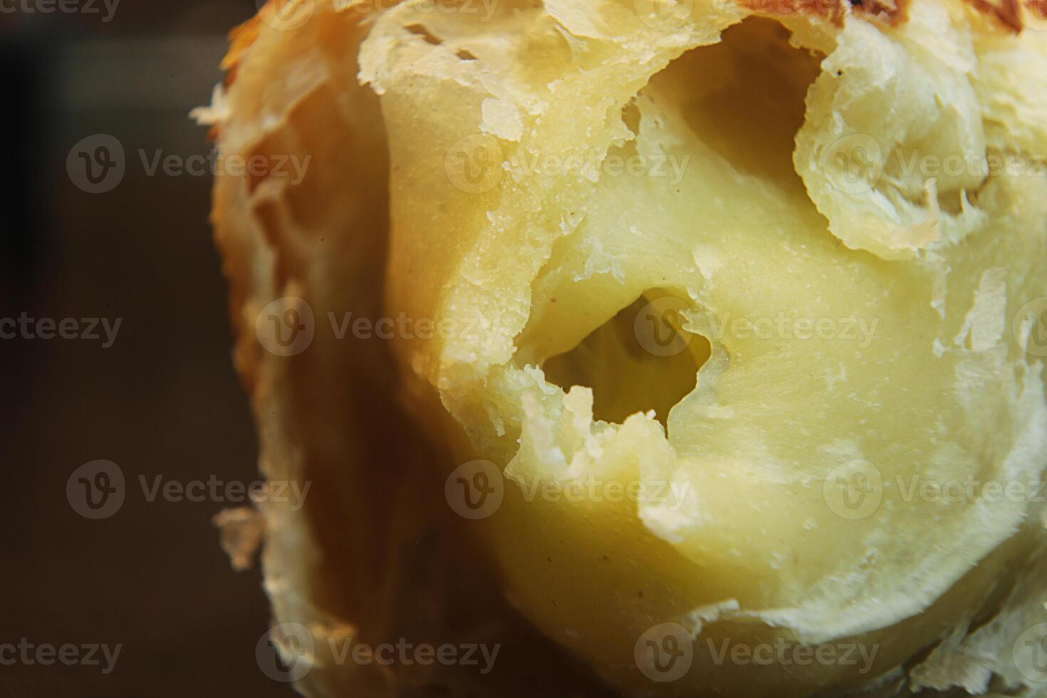 macrophotography of the insides of a bread filled with cheese photo
