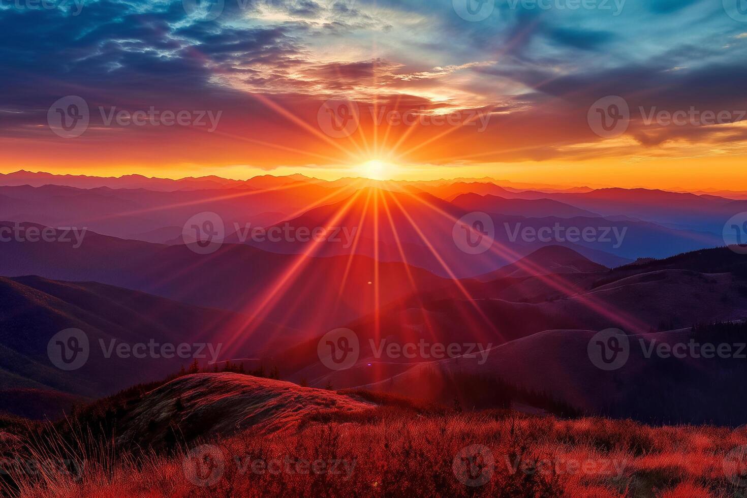 The sky glows orange and red at sunset over the mountains photo