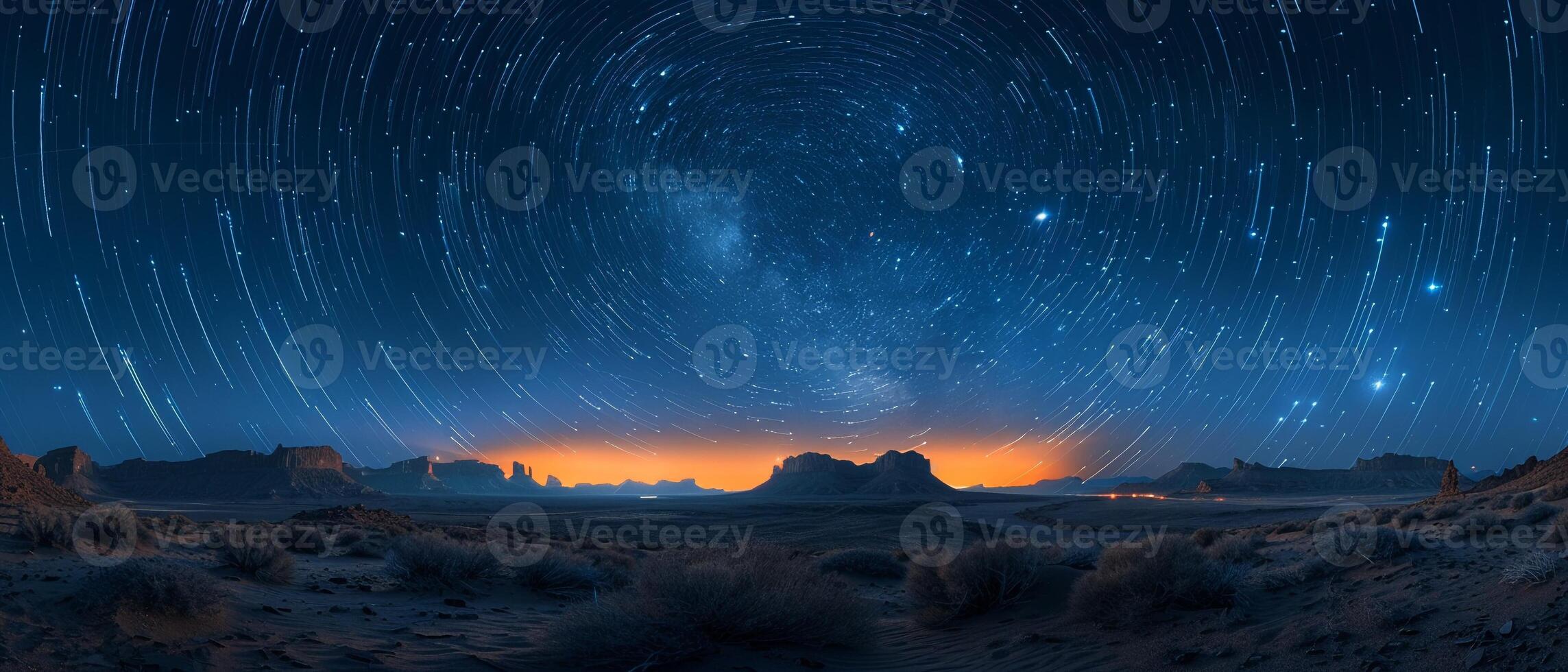 Stars trailing in the night sky over a silent desert photo