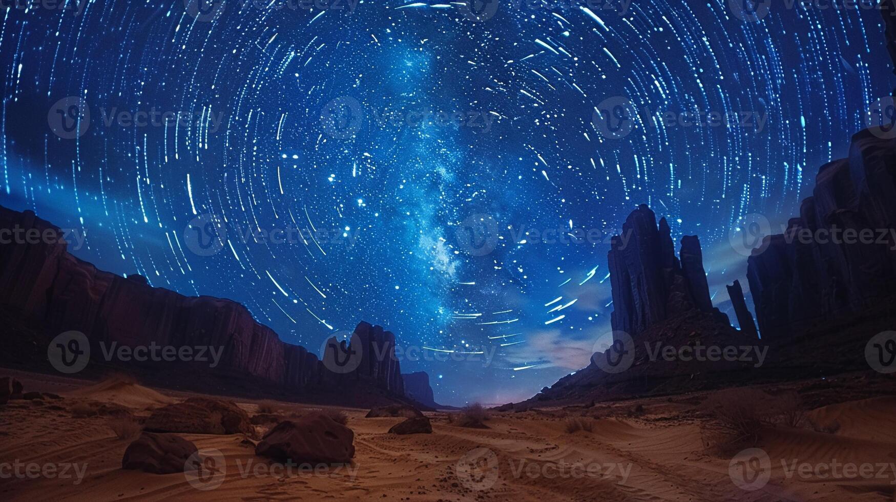 Stars trailing in the night sky over a silent desert photo