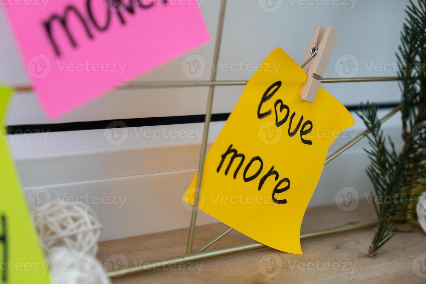 LOVE MORE goal on Vision board with new year resolutions aims on sticky notes. Preparation for New Year. Concept of planning and setting goals for personal development photo