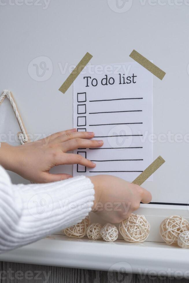 Unrecognizable woman creating vision board with Motivational paper note TO DO LIST. Goals setting concept. Strategy for self development improvement. Inspirational Planning better healthier life. Visual motivation photo