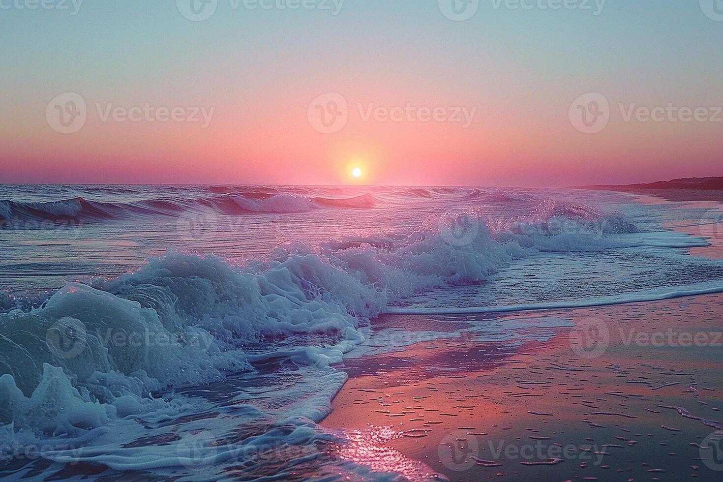 Gentle waves lapping at a sandy beach under a pastel sunset photo