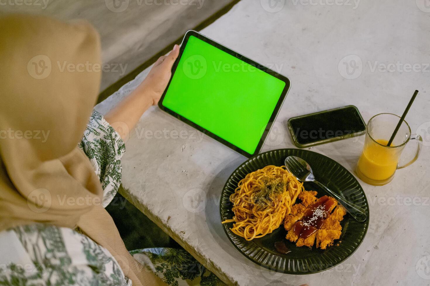 Green Screen iPad or Tablet with Cafe Ambiance and Food on Table photo