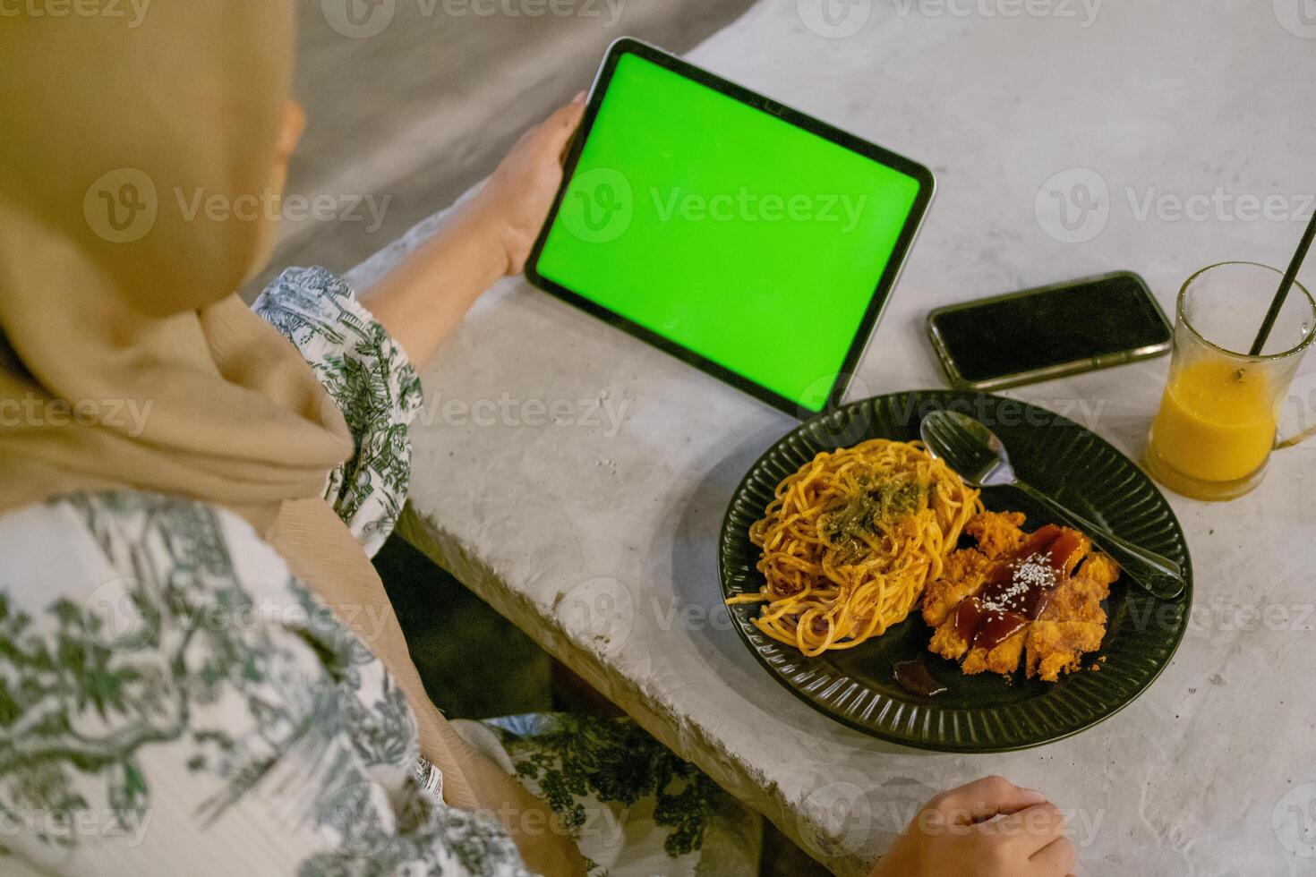Green Screen iPad or Tablet with Cafe Ambiance and Food on Table photo