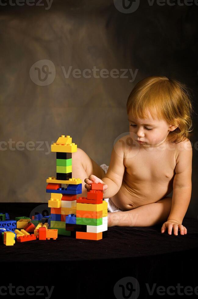 Small girl plays with the designer photo
