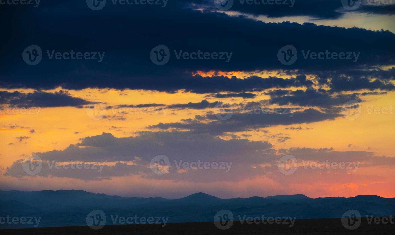view of a valley in a beautiful early night with fog between hills photo