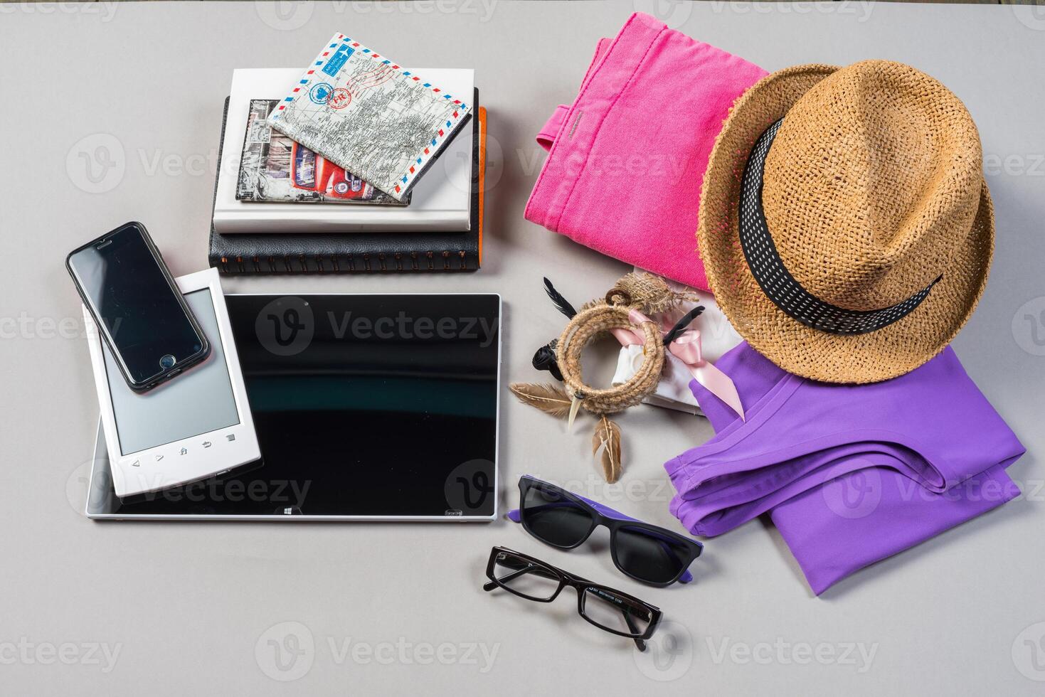 Mock up of summer traveling stuff on grey background. photo