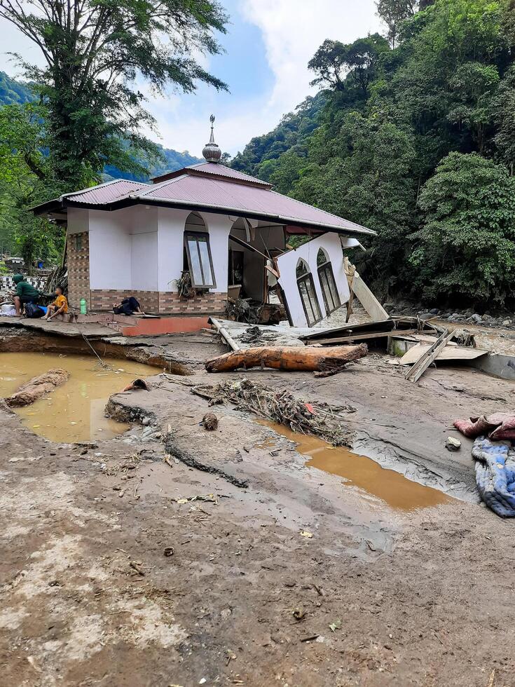 Tanah Datar, Indonesia - May 12, 2024. condition of the mosque affected by cold lava flash floods. Natural Disaster in Lembah Anai, Sepuluh Koto District, Tanah Datar, West Sumatra, Indonesia photo
