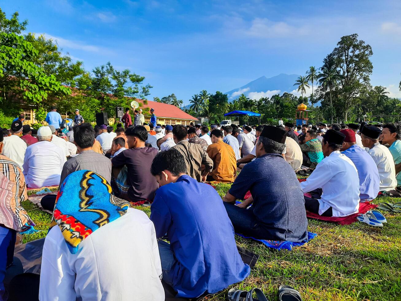 Padang Pariaman, Indonesia - April 10, 2024. Muslims perform Eid al-Fitr prayers in the field in Kayutanam, Padang Pariaman Regency photo