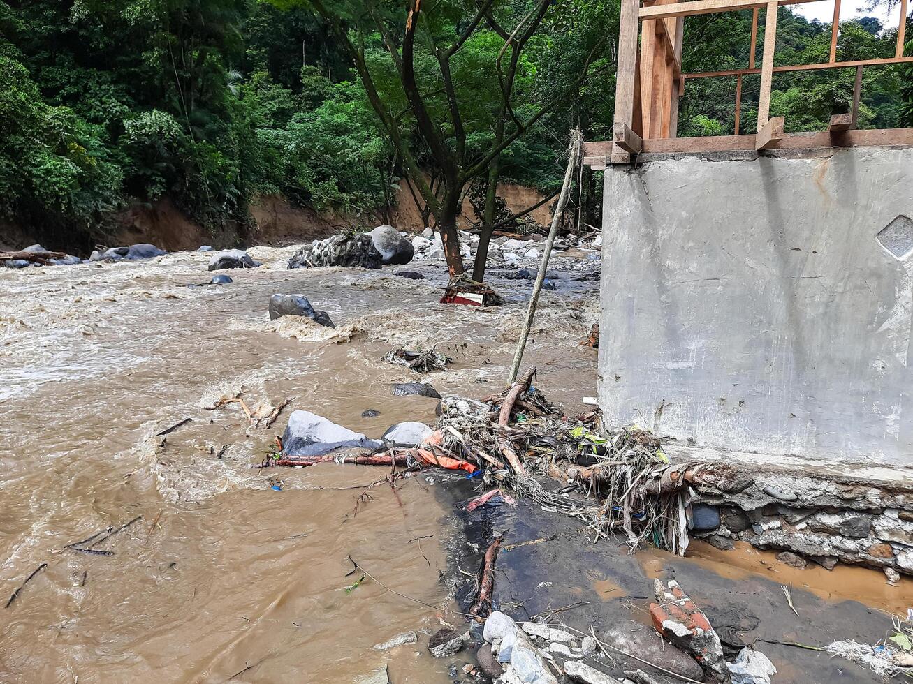 Tanah Datar, Indonesia - May 12, 2024. The back of a building affected by cold lava flash floods, a natural disaster in Lembah Anai, Sepuluh Koto District, Tanah Datar Regency, West Sumatra, Indonesia photo