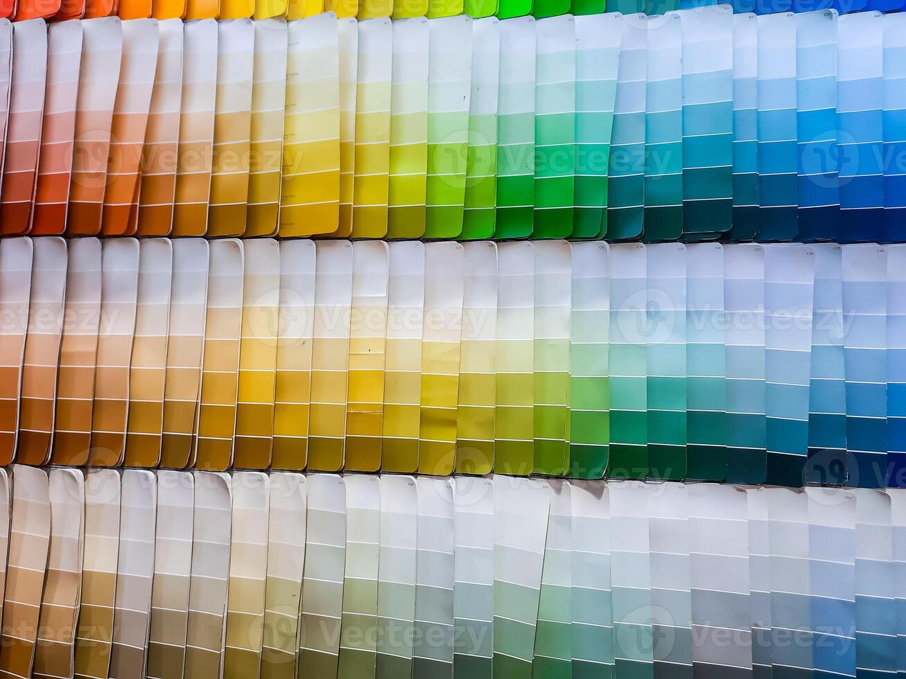 paper color palettes on a shelf in a wall paint supply store, guide of paint samples catalog photo