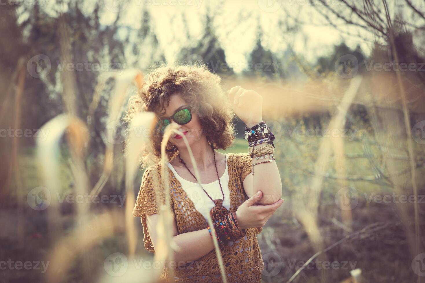 Fashion shot of a beautiful boho style girl on nature background. Boho, hippie photo