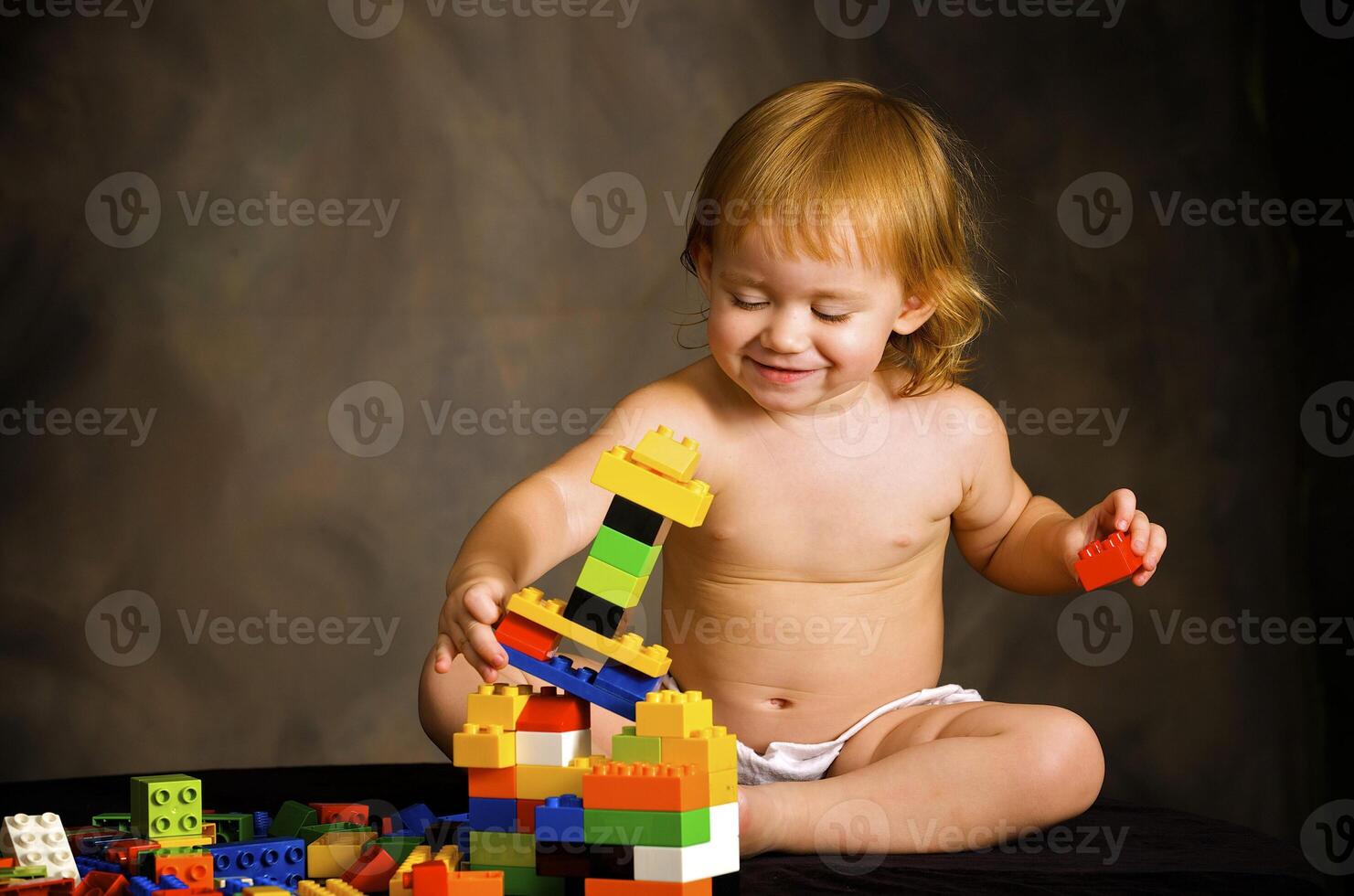 Small girl plays with the designer photo
