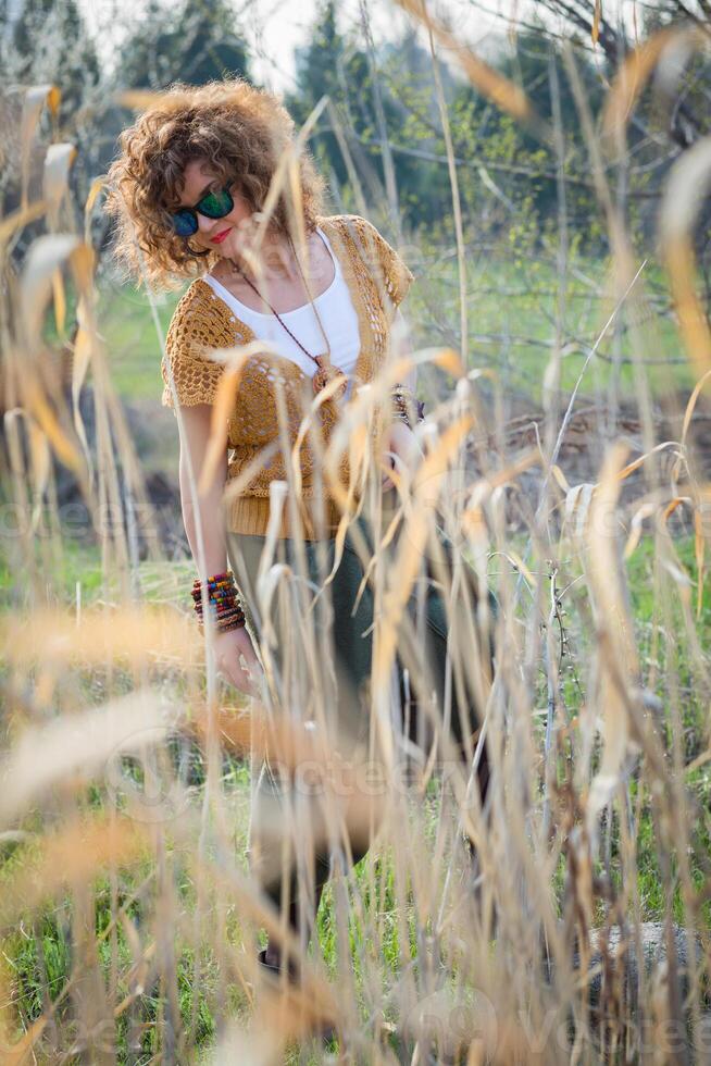 Fashion shot of a beautiful boho style girl on nature background. Boho, hippie photo