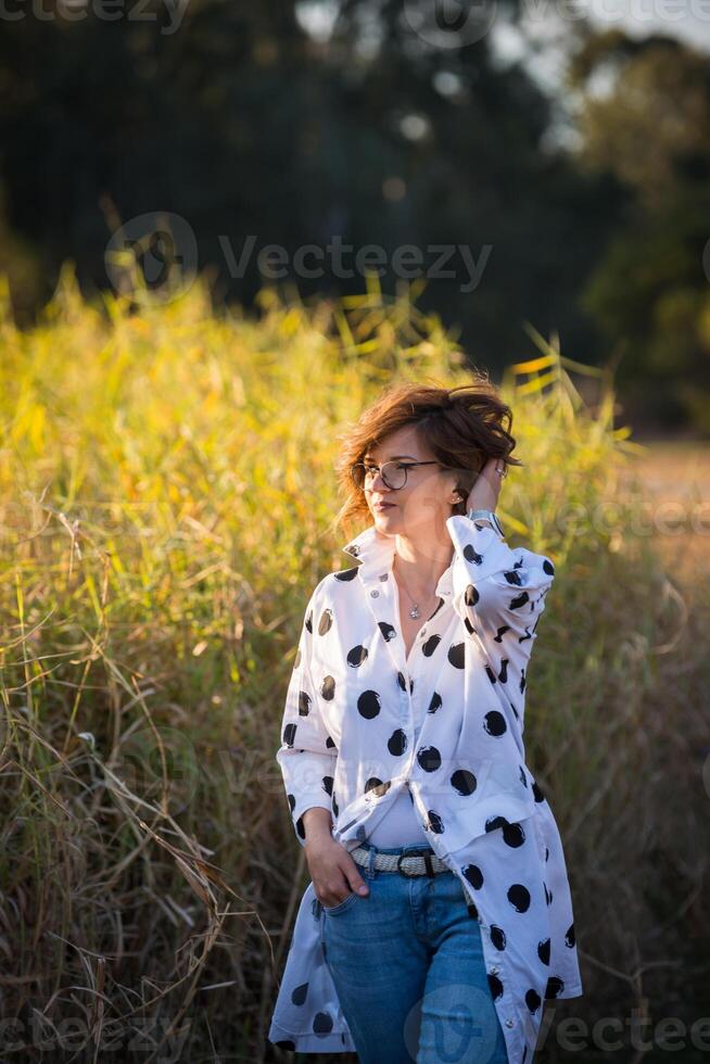 Fashion shot of a beautiful boho style girl on nature background. Boho, hippie. photo