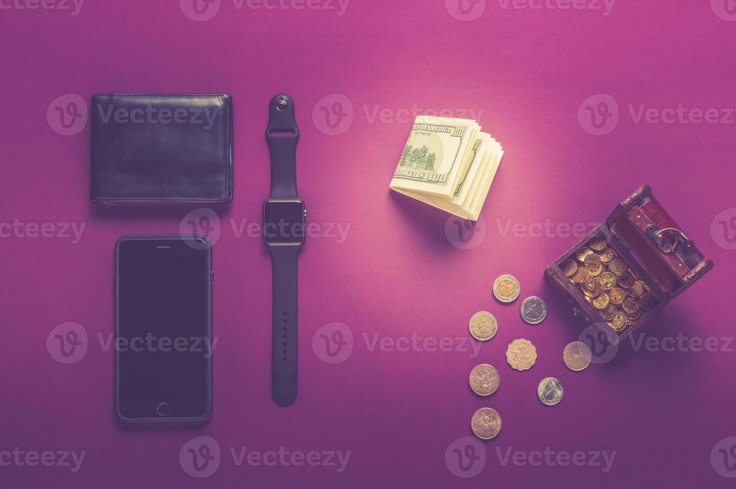 Business concept. Top view of dollars, watch, smartphone on color background photo