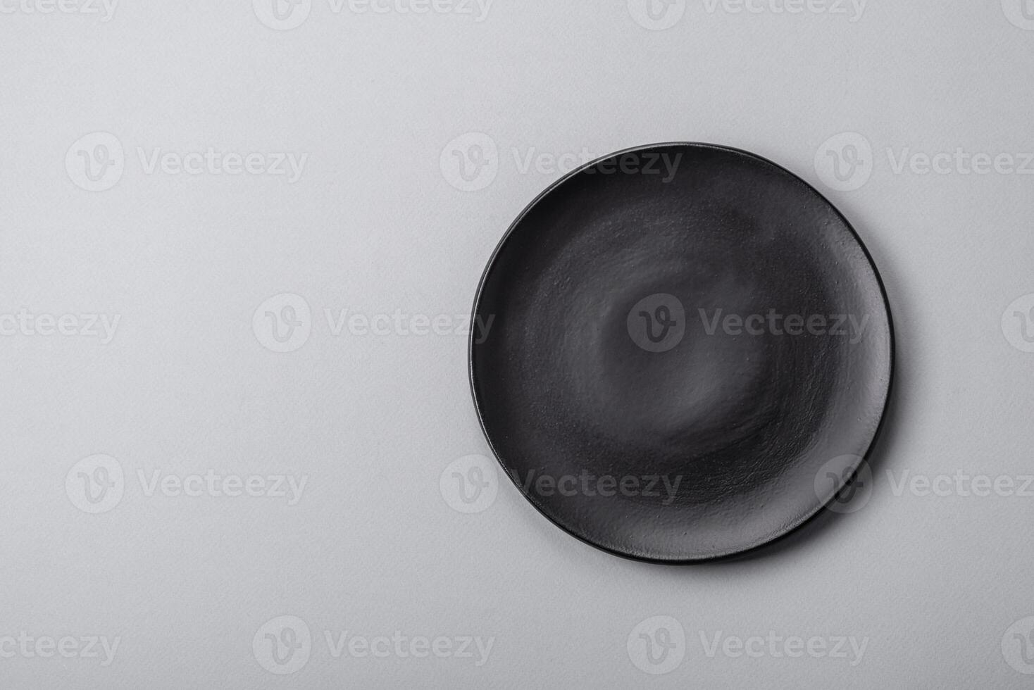 An empty plate on a gray concrete background with copy space photo