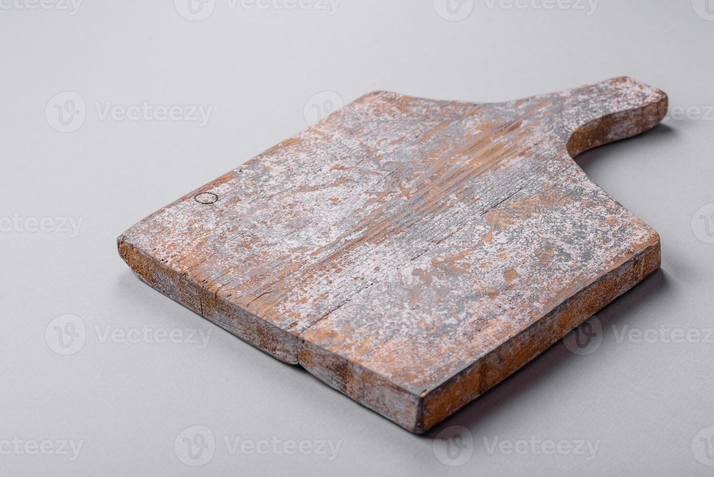 Empty wooden cutting board on gray textured concrete background photo