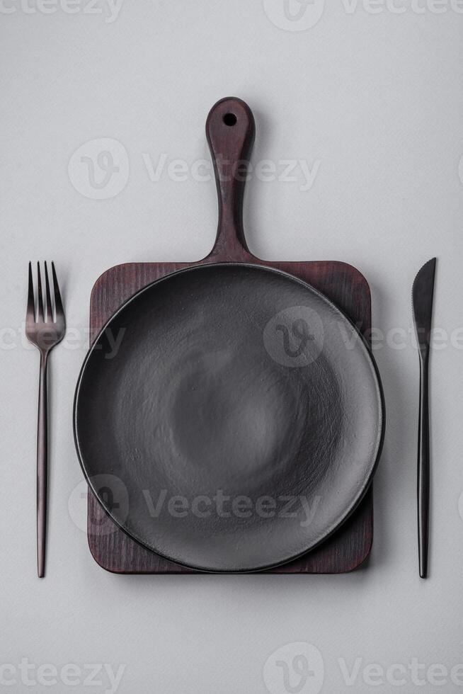 An empty plate on a gray concrete background with copy space photo