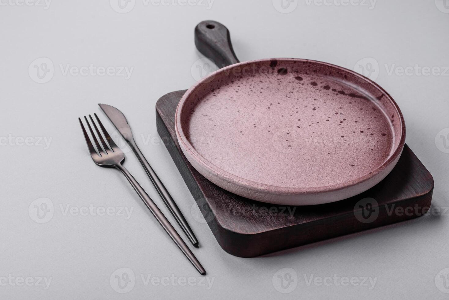 An empty plate on a gray concrete background with copy space photo