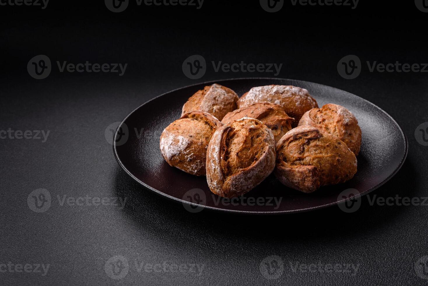 Fresh baked bread buns with salt, spices, seeds and grains photo