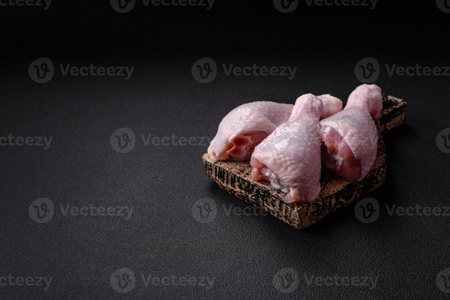 Fresh raw chicken legs with salt and spices photo
