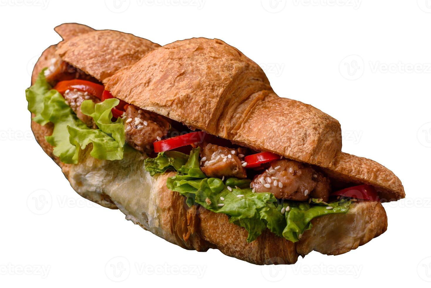 Delicious fresh crispy croissant with chicken or beef meat, lettuce, tomatoes, spices and sauce photo
