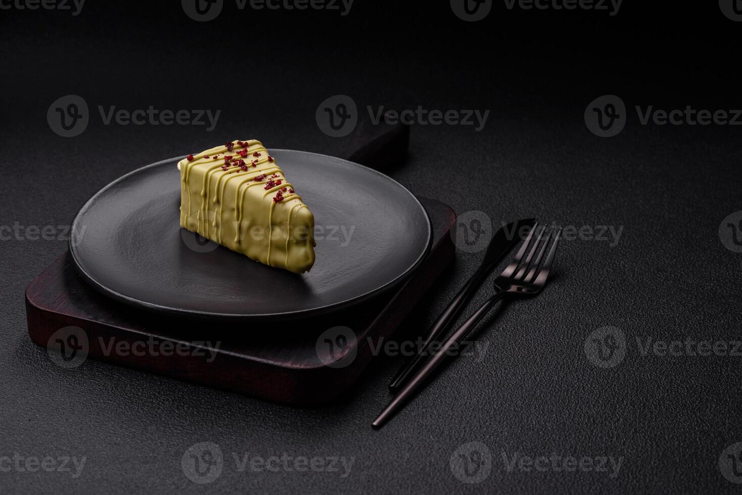 Delicious sweet cheesecake with fruits covered with icing with a wooden stick photo