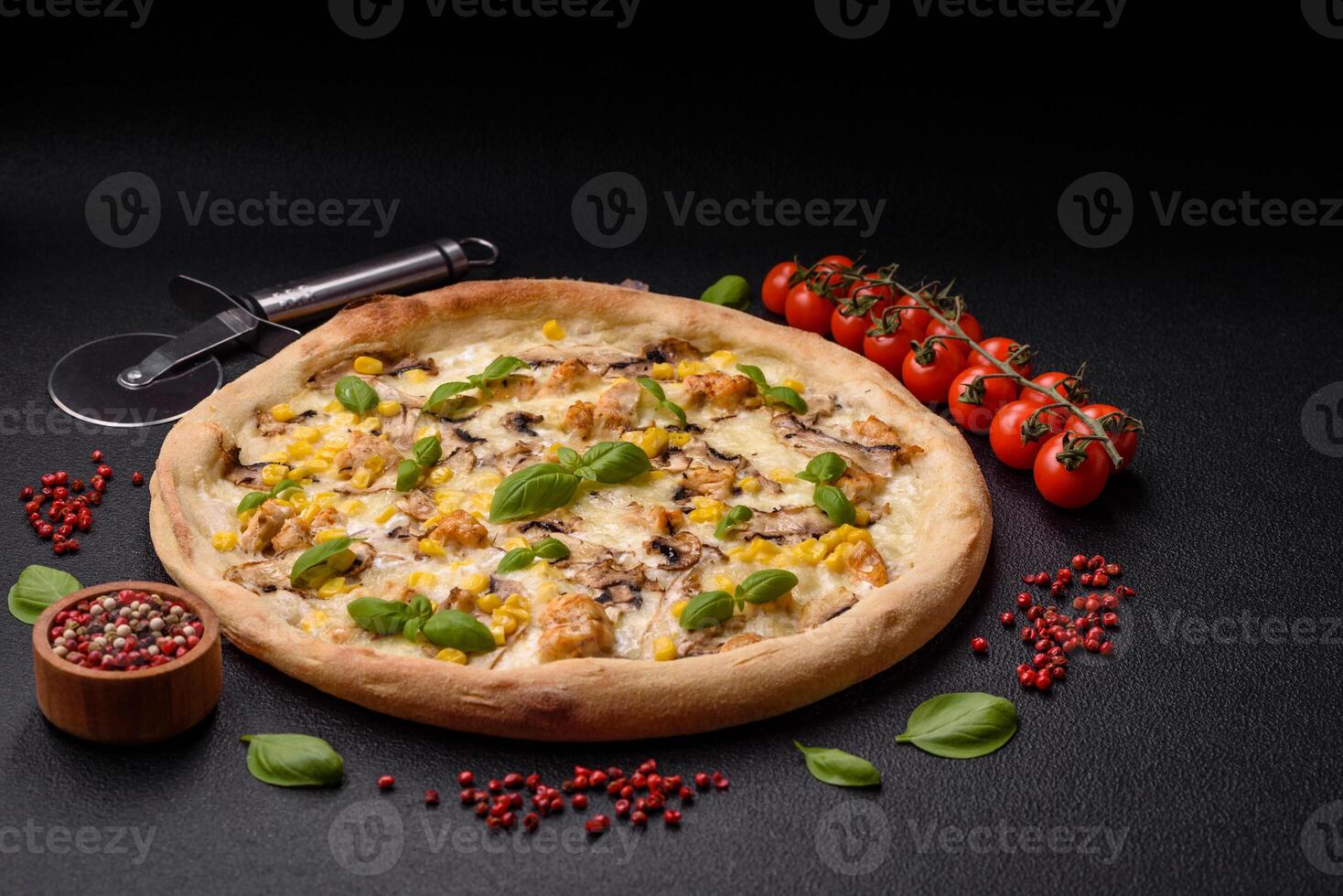 Delicious pizza with corn, cheese, tomatoes and mushrooms, salt, spices and herbs photo