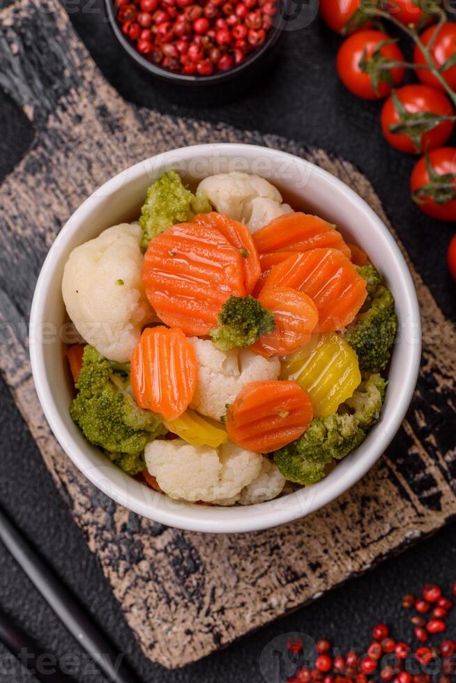 Delicious fresh vegetables broccoli, cauliflower, carrots steamed with salt photo