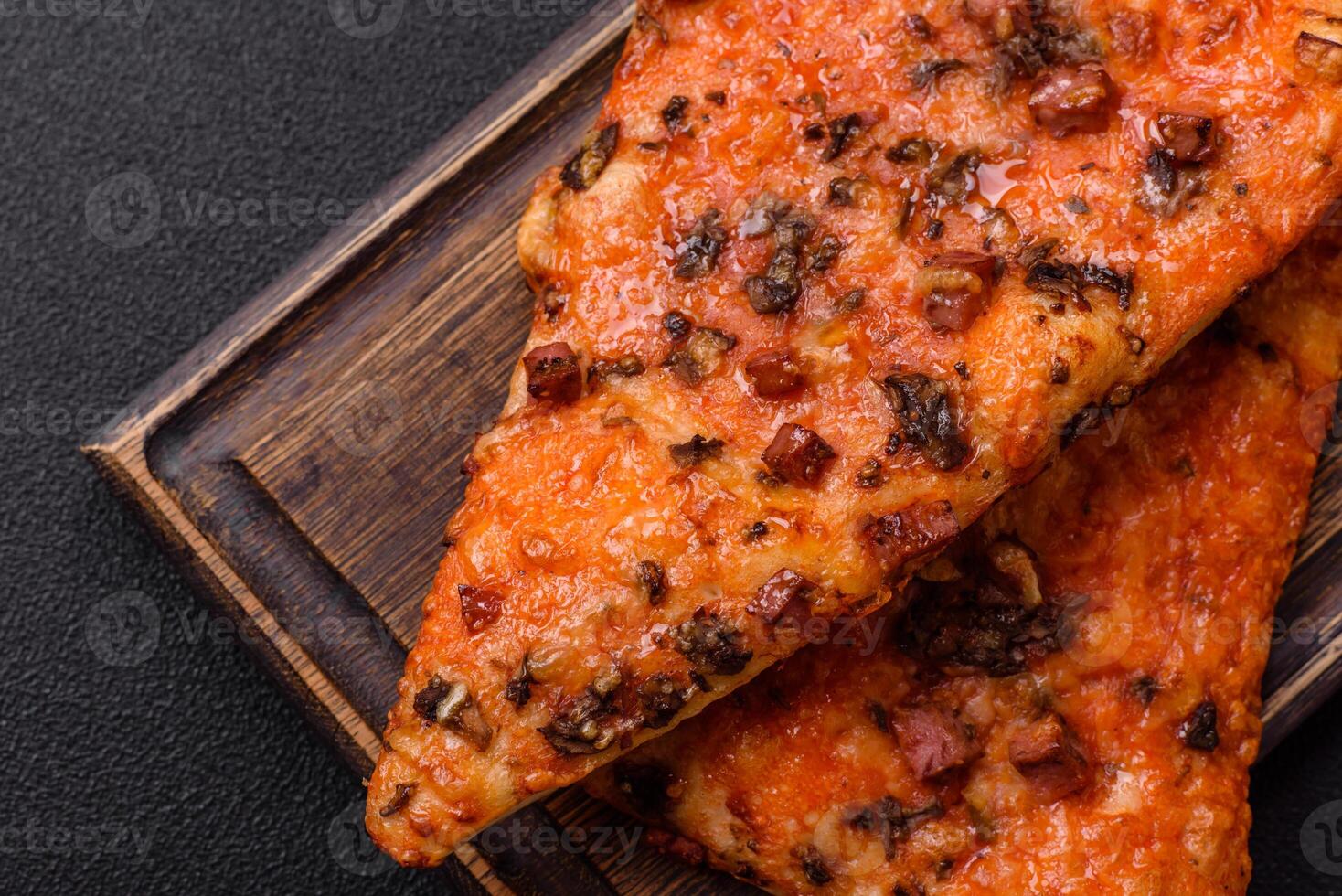 Slices of delicious street pizza with sausage, mushrooms, tomatoes and cheese photo