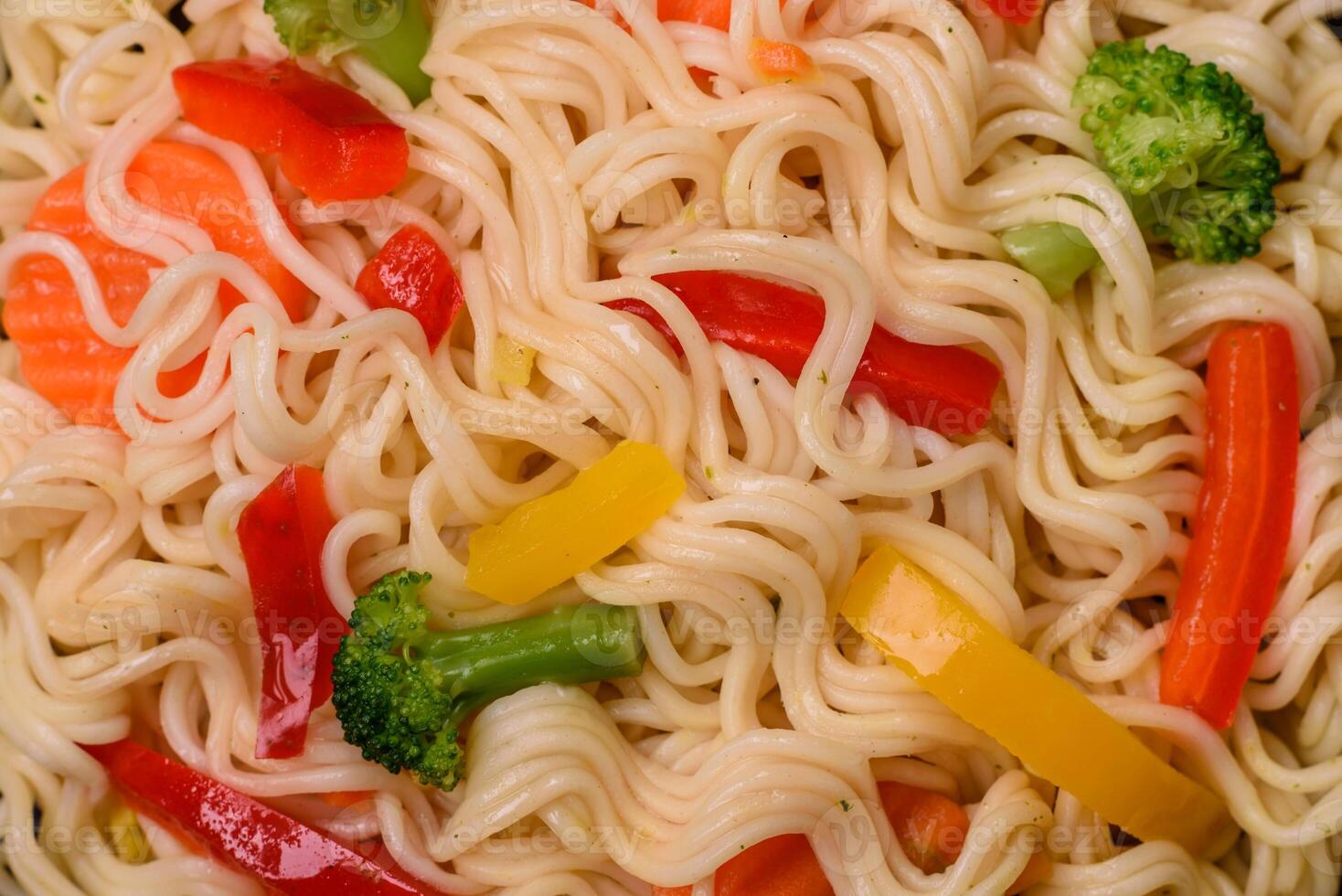 Delicious Asian dish rice noodles or udon with vegetables, spices and herbs photo