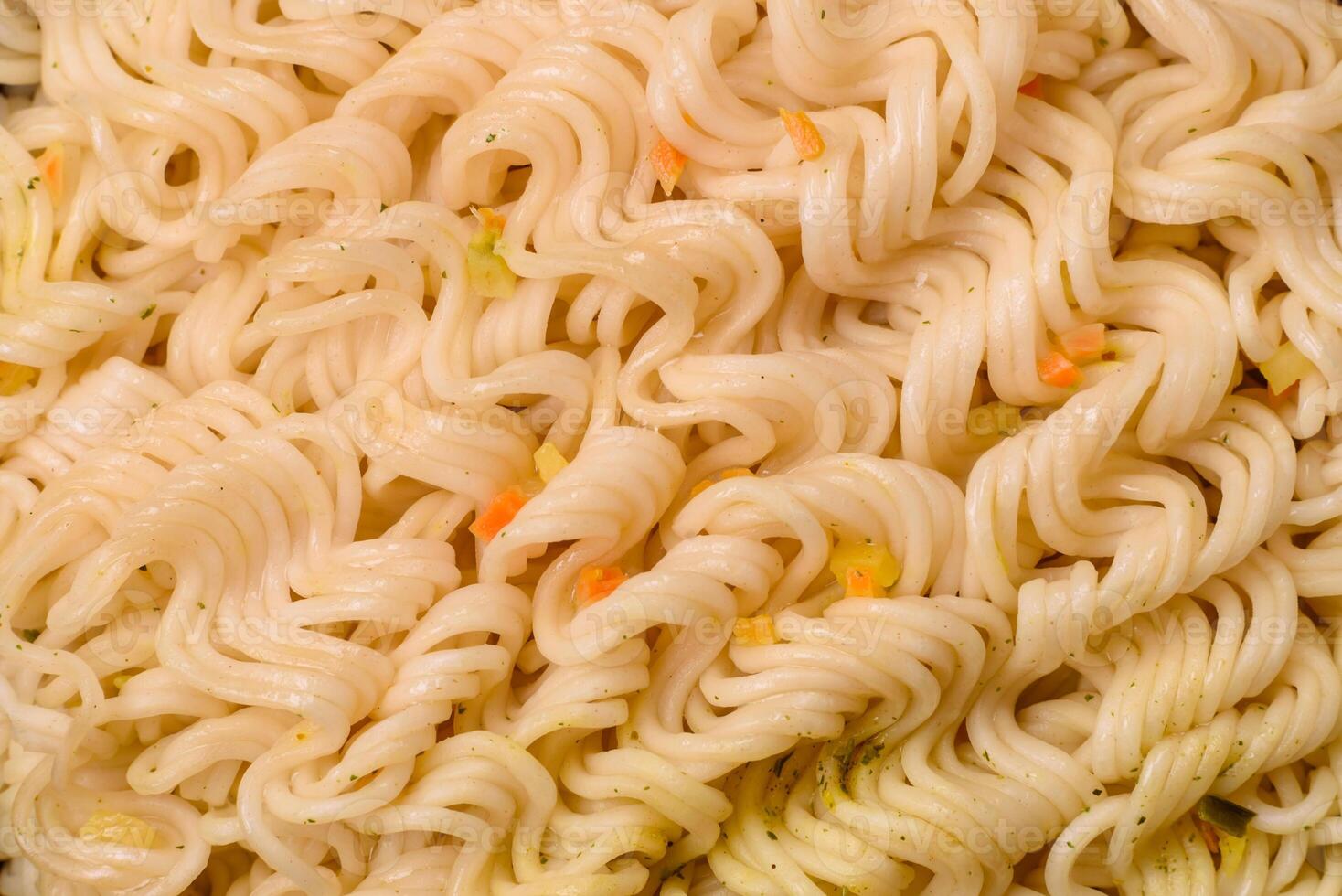 Delicious Asian dish rice noodles or udon with vegetables, spices and herbs photo