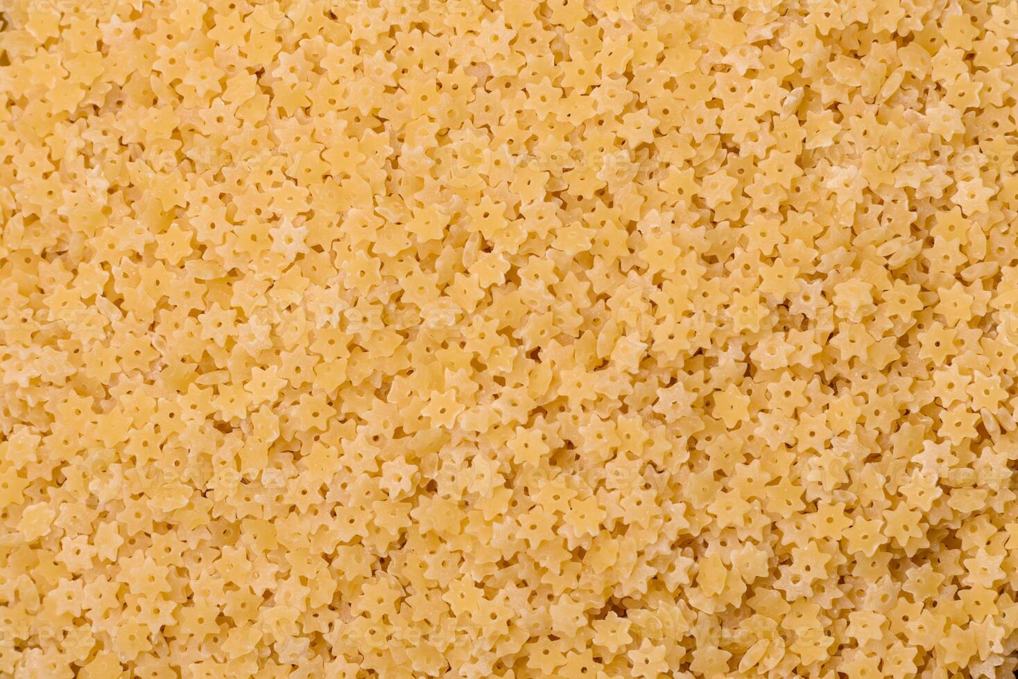 Raw stelline pasta from durum wheat with salt and spices photo
