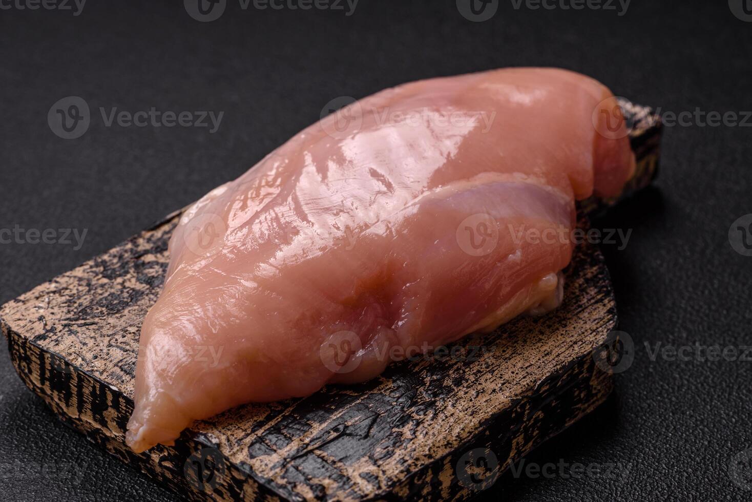 Raw chicken fillet with salt, spices and herbs photo