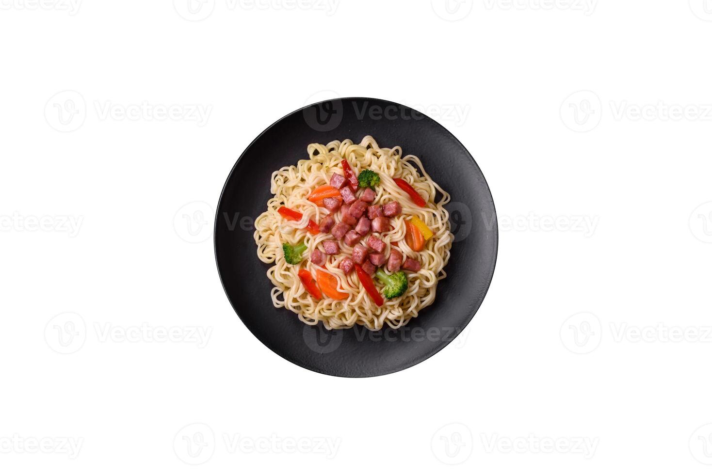 Delicious Asian dish rice noodles or udon with vegetables, spices and herbs photo