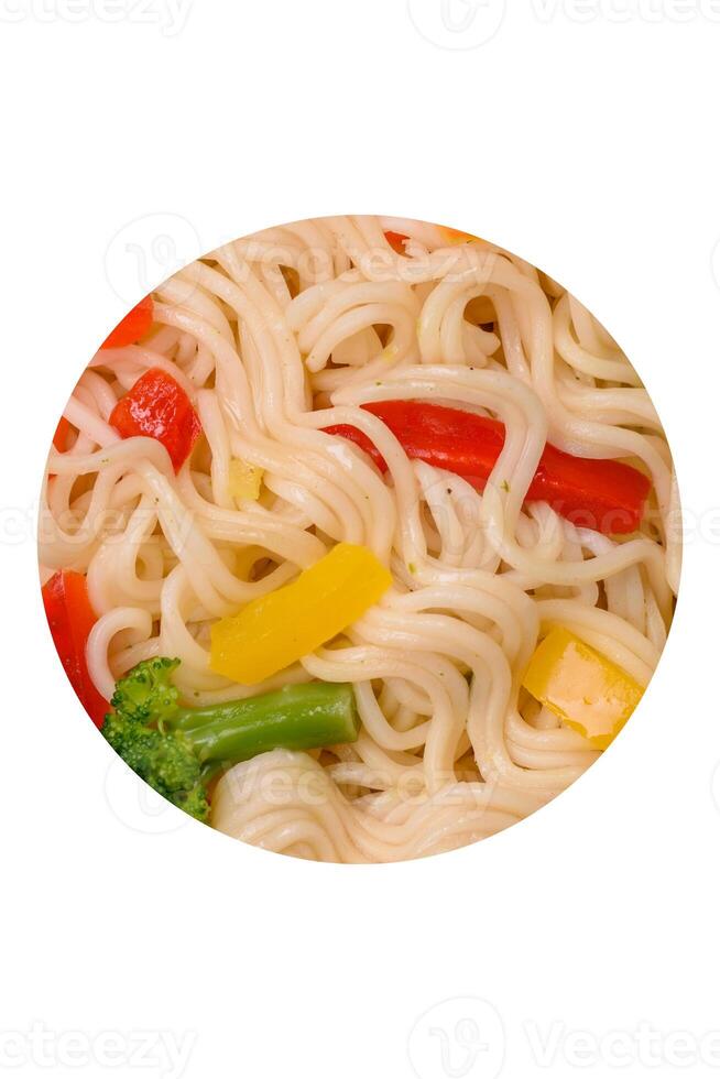 Delicious Asian dish rice noodles or udon with vegetables, spices and herbs photo