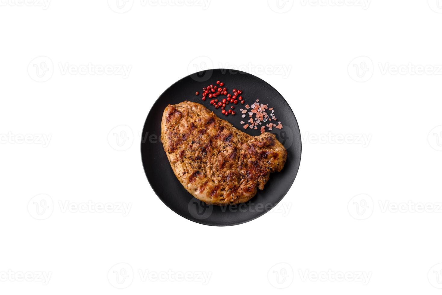 Delicious juicy pork steak with salt, spices and herbs photo