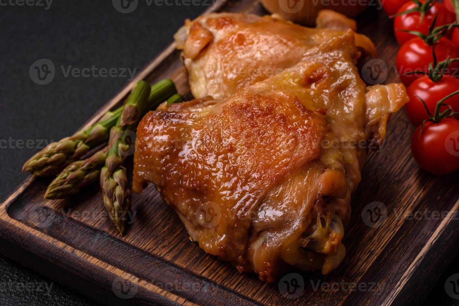 Delicious juicy chicken thighs baked on the grill with salt photo