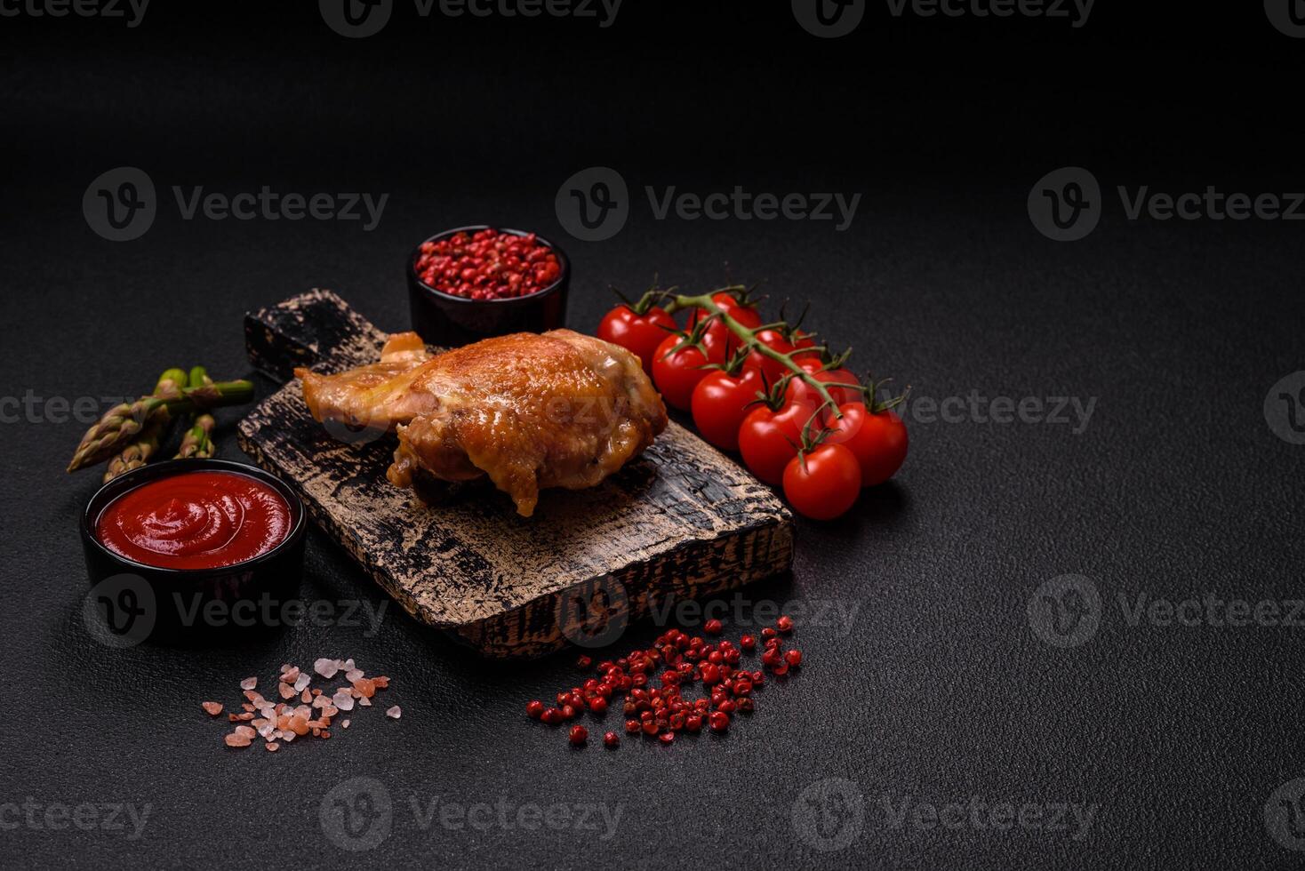 Delicious juicy chicken thighs baked on the grill with salt photo