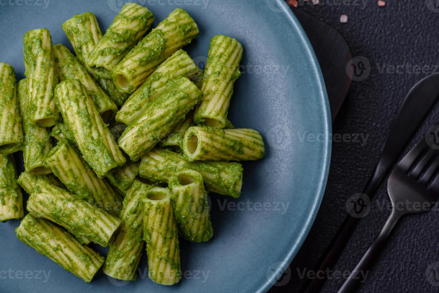 Delicious pasta with spinach sauce, olive oil and parmesan cheese photo