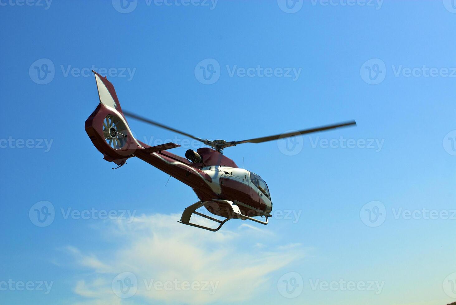 Helicopter flying over the river photo