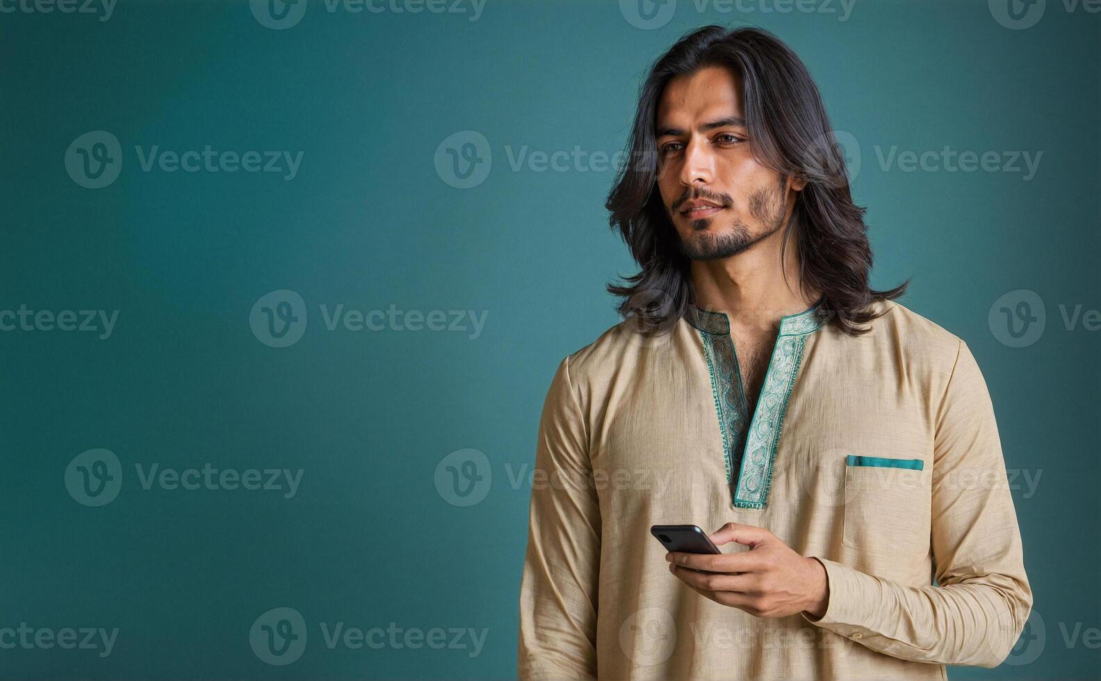 Traditional South Asian Man in Embroidered Kurta with Smartphone - Studio Portrait photo
