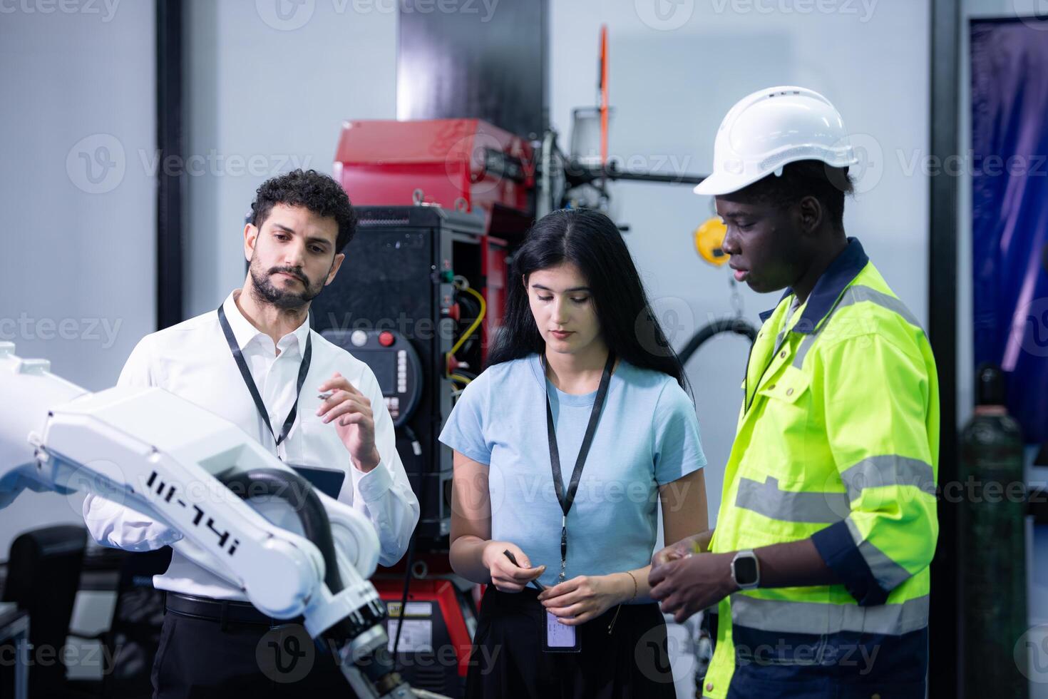 Technicians are introducing industrial hand robots to businessperson of factory industry who will use them in large-scale complex manufacturing operations. photo