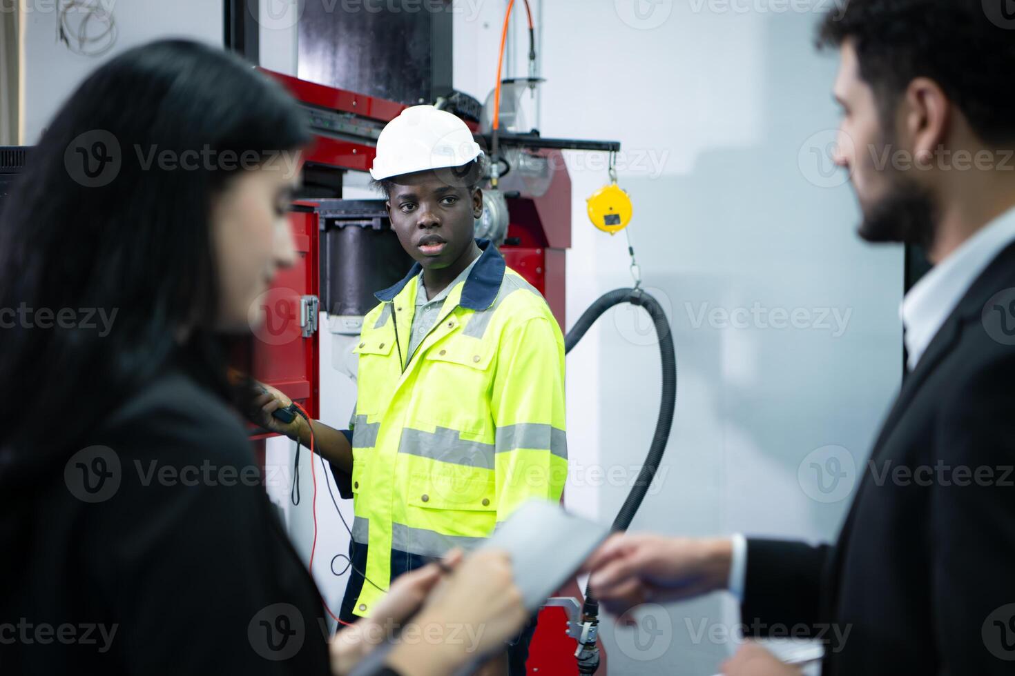 Technicians are introducing industrial hand robots to businessperson of factory industry who will use them in large-scale complex manufacturing operations. photo
